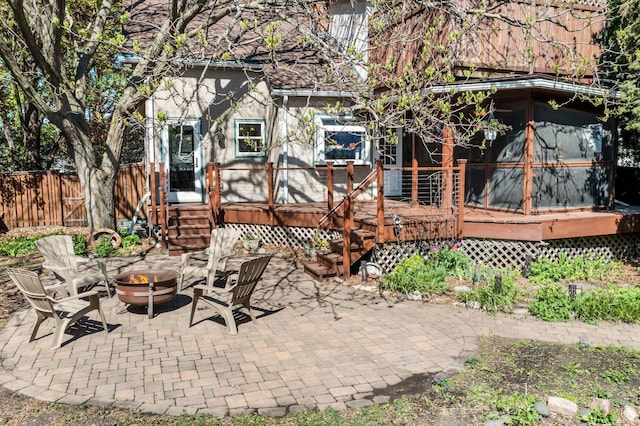 back of house with a patio area, a fire pit, fence, and stucco siding