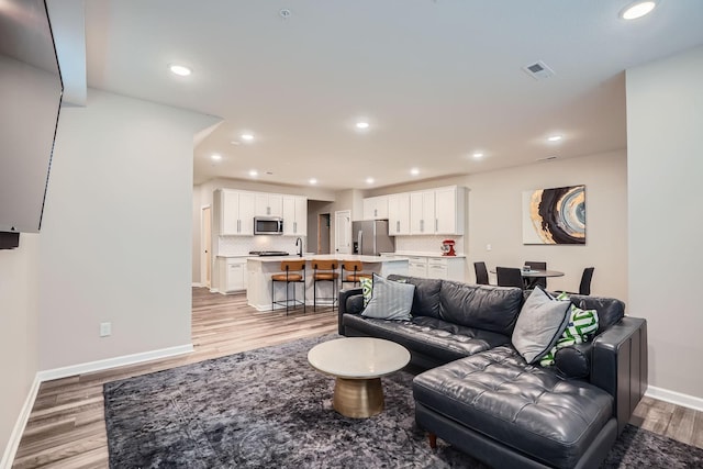17935 Giants Way, Lakeville, MN 55044 - living area with light wood-type flooring, recessed lighting, and baseboards