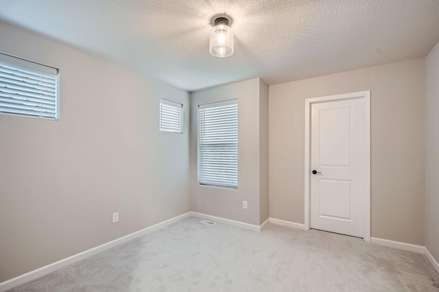 17935 Giants Way, Lakeville, MN 55044 - unfurnished bedroom featuring a textured ceiling, light carpet, and baseboards