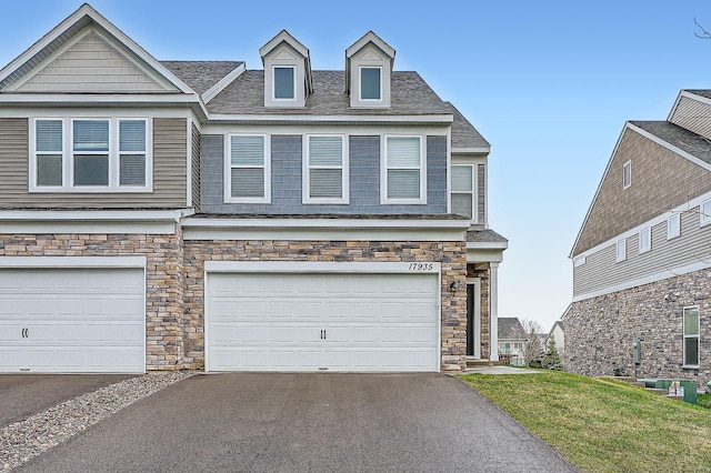 17935 Giants Way, Lakeville, MN 55044 - view of front facade featuring stone siding, driveway, and a garage