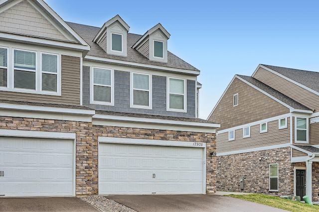 17935 Giants Way, Lakeville, MN 55044 - view of front facade with stone siding, a garage, and driveway