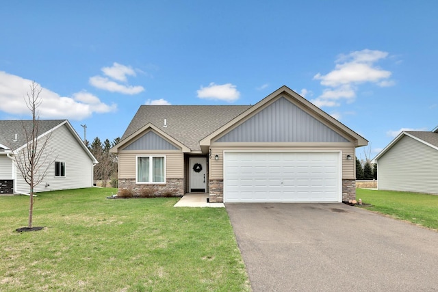 view of front of house with board and batten siding, driveway, a front lawn, an attached garage, and stone siding
