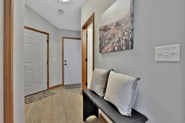 foyer entrance with baseboards and light wood-style floors