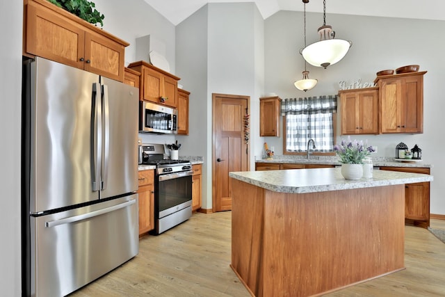 kitchen featuring light wood-style floors, high vaulted ceiling, light countertops, a sink, and appliances with stainless steel finishes
