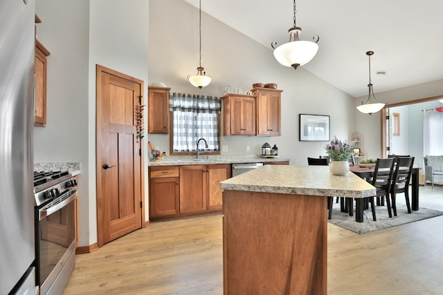 kitchen featuring light wood-style floors, light countertops, a sink, and stainless steel appliances