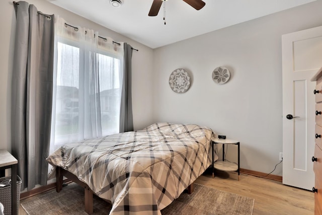 bedroom with baseboards, a ceiling fan, and wood finished floors