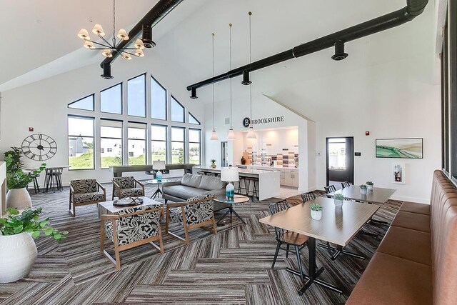 17121 Dysart Pl, Lakeville, MN 55044 - living room featuring high vaulted ceiling, a chandelier, and carpet