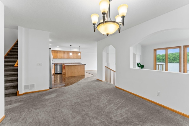 6300 Linden Ln, Mound, MN 55364 - unfurnished living room with carpet, baseboards, arched walkways, and a chandelier