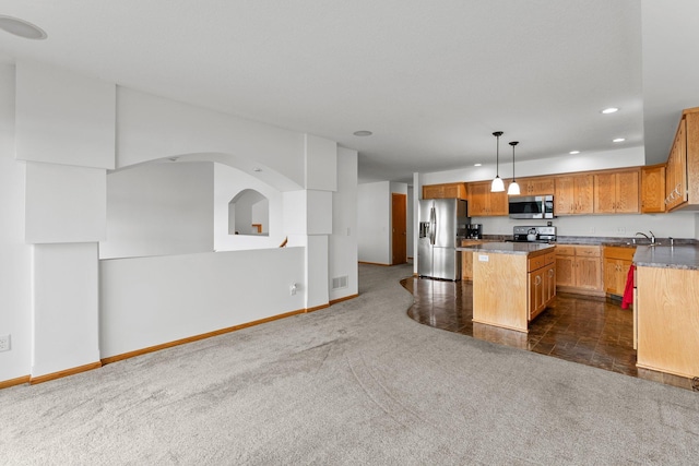 6300 Linden Ln, Mound, MN 55364 - kitchen with stainless steel appliances, open floor plan, recessed lighting, a center island, and dark colored carpet