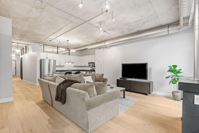living room with light wood-style floors and baseboards