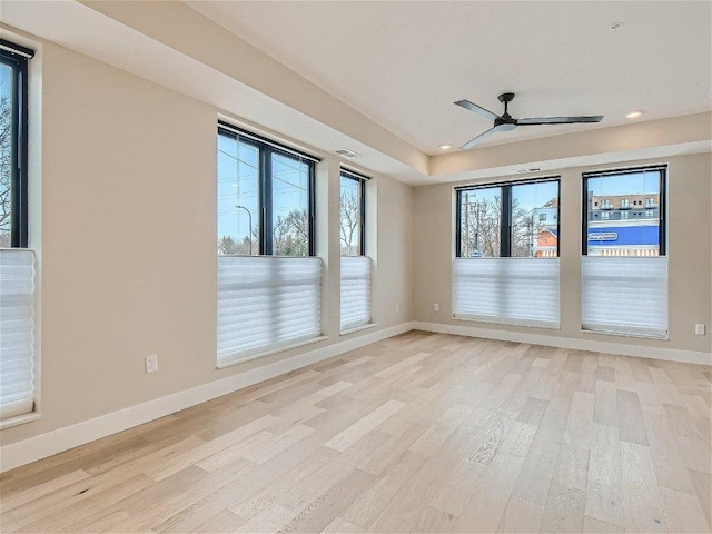 empty room featuring recessed lighting, baseboards, a ceiling fan, and light wood-type flooring