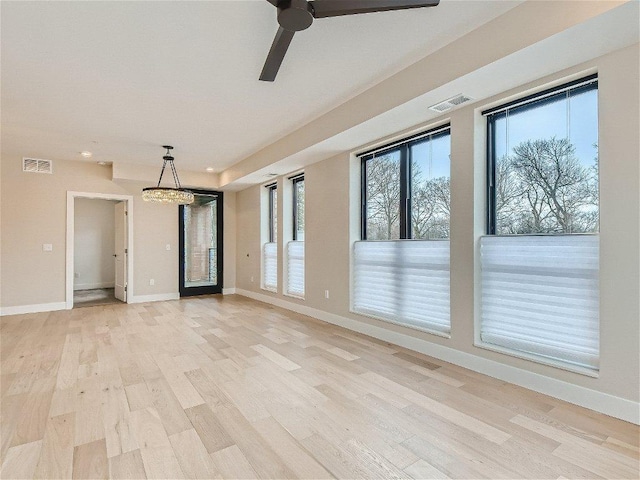 spare room with visible vents, light wood-style flooring, and a wealth of natural light