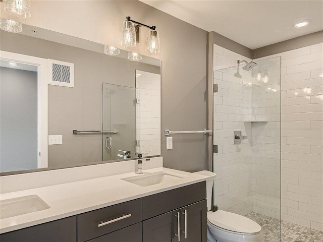 full bath featuring double vanity, a sink, and a stall shower