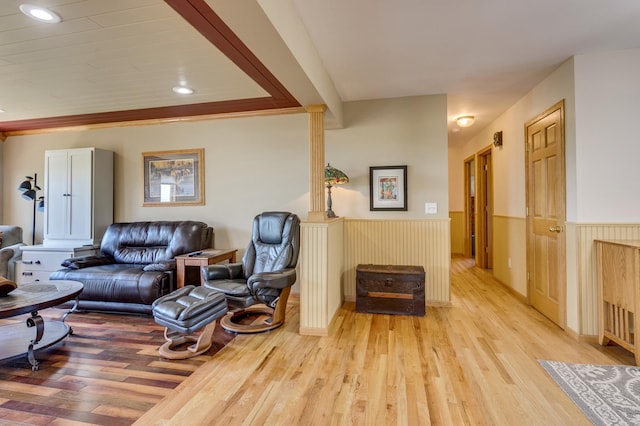 living area featuring recessed lighting, light wood finished floors, and a wainscoted wall
