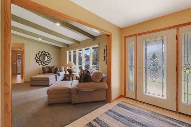 living area with light tile patterned flooring, beam ceiling, and a wealth of natural light