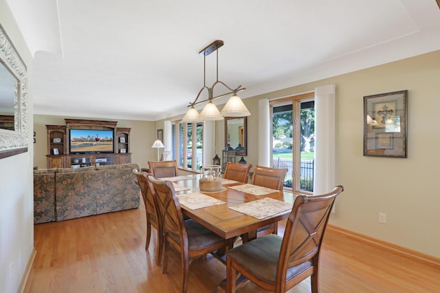 dining space with light wood-style floors and baseboards