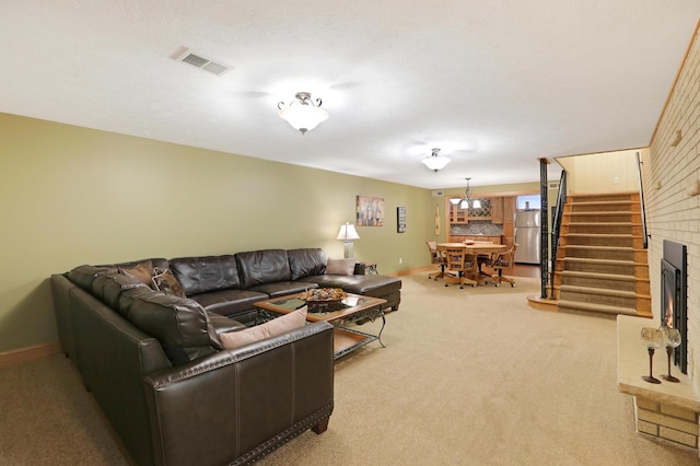 living room with carpet flooring, baseboards, and stairs