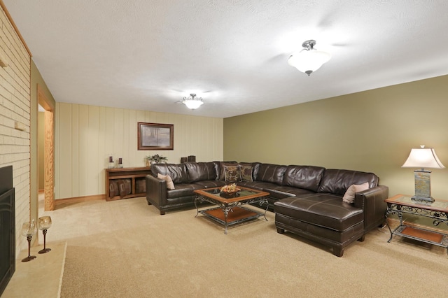 carpeted living area with a brick fireplace