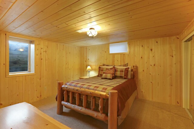 bedroom featuring carpet flooring, wooden walls, and wooden ceiling