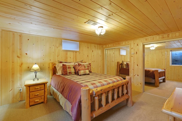 bedroom featuring wooden walls, wood ceiling, multiple windows, and light carpet
