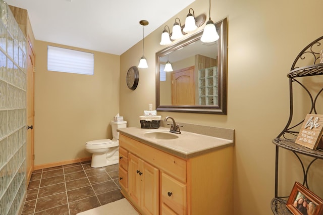 bathroom featuring vanity, tile patterned flooring, baseboards, and toilet
