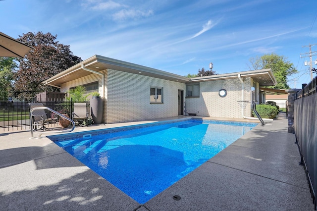 view of swimming pool with a fenced in pool, fence, and a patio