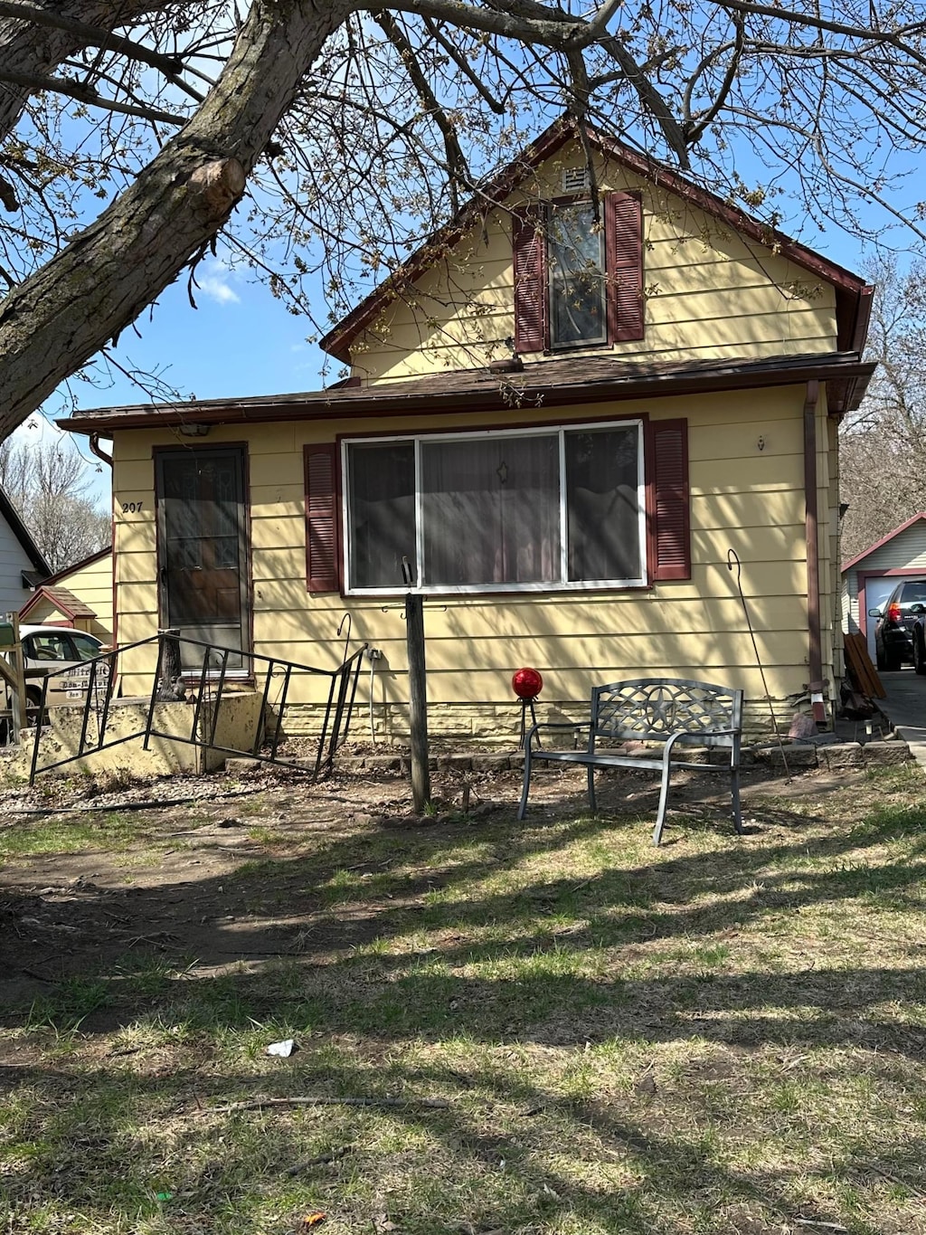 view of side of home with a yard