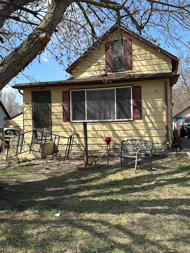 view of side of home with a yard
