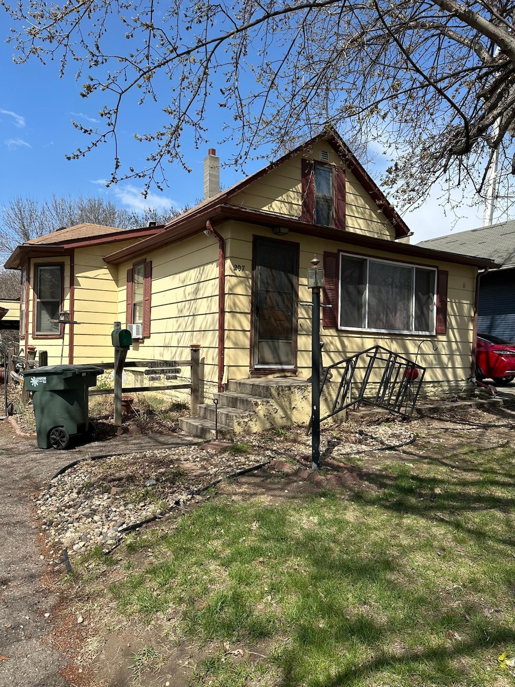 view of front of house with a front lawn and a chimney