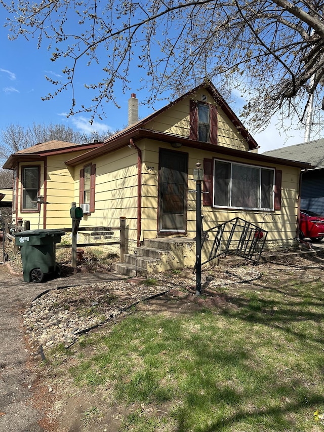 view of front of house with a front lawn and a chimney