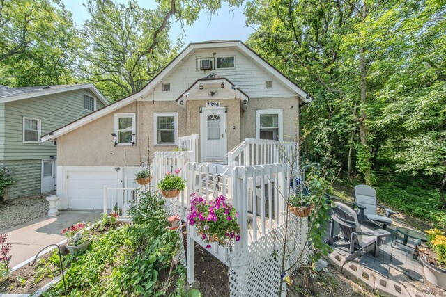 2394 Valentine Ave, Saint Paul, MN 55108 - bungalow-style house with stucco siding, concrete driveway, and a garage