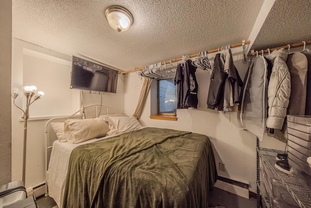 2394 Valentine Ave, Saint Paul, MN 55108 - bedroom featuring a textured ceiling, baseboards, and a baseboard heating unit