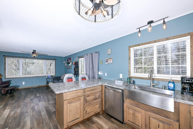 kitchen with light countertops, a ceiling fan, a sink, dark wood finished floors, and dishwasher