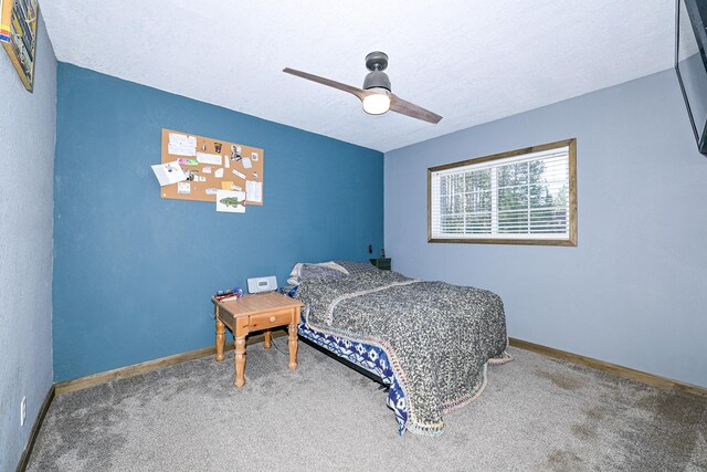 bedroom with baseboards, a textured ceiling, ceiling fan, and carpet floors