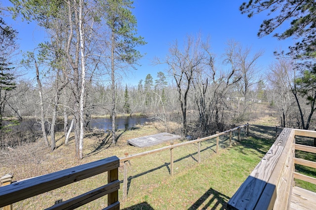 view of yard featuring a water view and fence