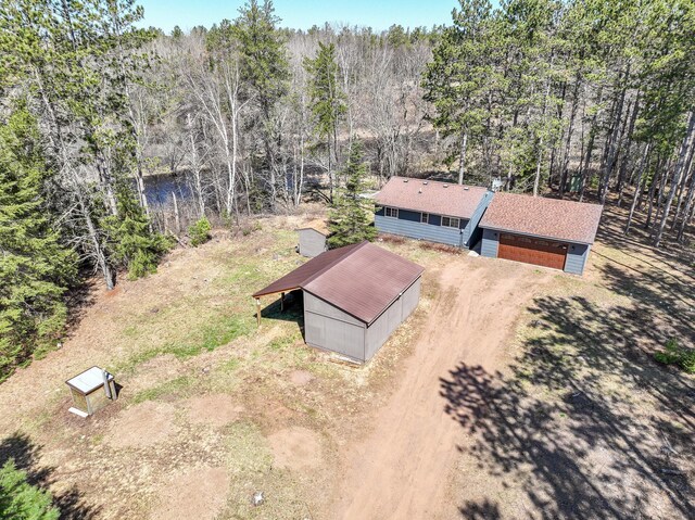 drone / aerial view with a wooded view