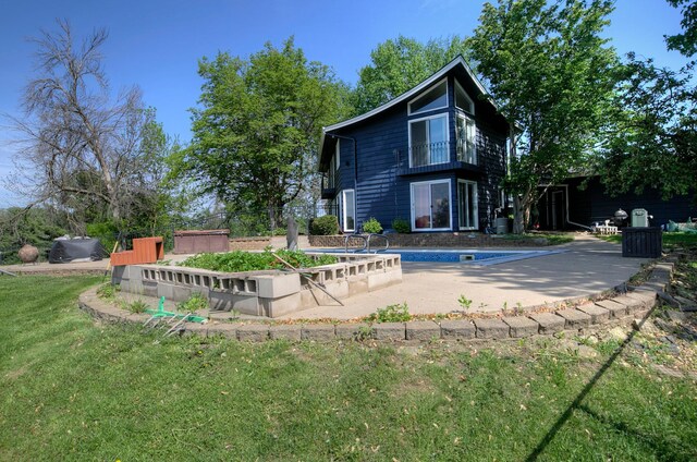 1224 Tee Up Ln, Red Wing, MN 55066 - rear view of house featuring an outdoor pool, a patio area, and a yard