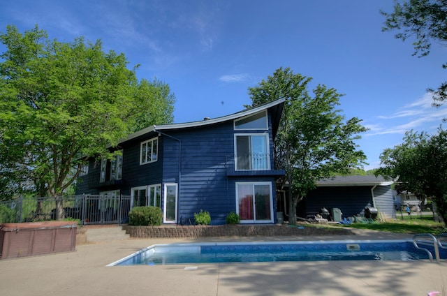 1224 Tee Up Ln, Red Wing, MN 55066 - back of property with a hot tub, an outdoor pool, and a patio area