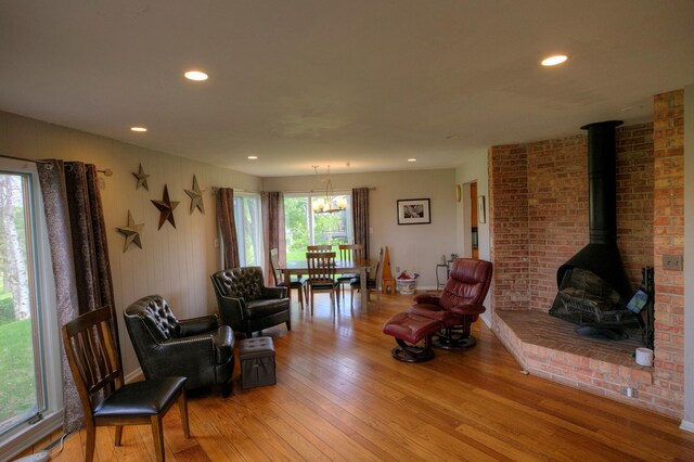 1224 Tee Up Ln, Red Wing, MN 55066 - living room with light wood-type flooring, a wood stove, recessed lighting, and a chandelier