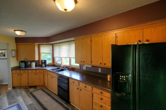 1224 Tee Up Ln, Red Wing, MN 55066 - kitchen featuring black appliances, a sink, light wood-style floors, a textured ceiling, and dark countertops