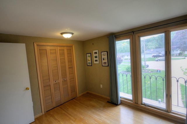 1224 Tee Up Ln, Red Wing, MN 55066 - unfurnished bedroom featuring light wood finished floors, a closet, and baseboards