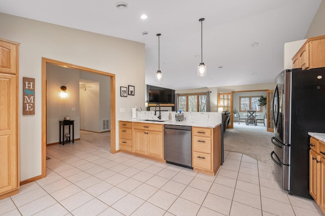 kitchen with light brown cabinetry, dishwasher, freestanding refrigerator, a peninsula, and visible vents