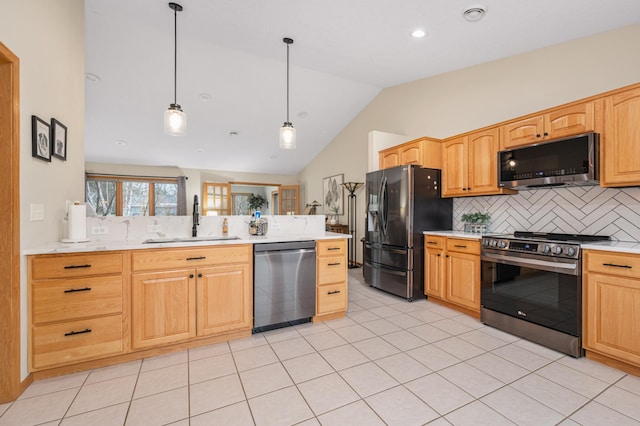 kitchen featuring tasteful backsplash, vaulted ceiling, a sink, light countertops, and stainless steel appliances