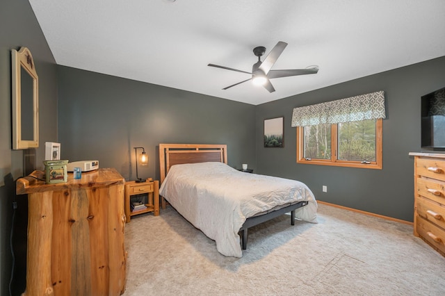 bedroom with baseboards, ceiling fan, and light carpet