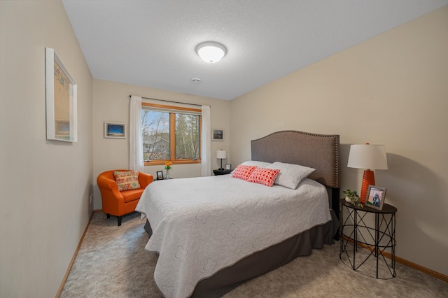 bedroom with baseboards, carpet flooring, and a textured ceiling