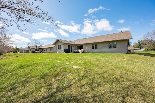 rear view of property featuring a yard
