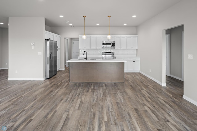 kitchen featuring a sink, stainless steel appliances, recessed lighting, and white cabinetry