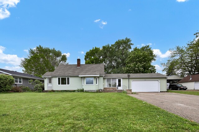1217 High St, Lake City, MN 55041 - single story home featuring a chimney, driveway, an attached garage, a front lawn, and roof with shingles