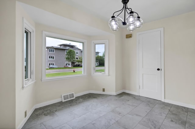 1217 High St, Lake City, MN 55041 - unfurnished dining area with a chandelier, marble look tiles, and baseboards