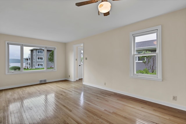 1217 High St, Lake City, MN 55041 - unfurnished room featuring healthy amount of natural light, hardwood / wood-style flooring, baseboards, and ceiling fan